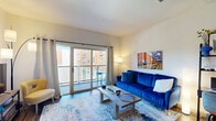 Located at 2645 Railroad Street in Pittsburgh's dynamic Strip District, this well-appointed one-bedroom, one-bathroom residence offers a thoughtfully designed open-concept layout. Hardwood-style flooring flows throughout, anchoring the bright and cohesive living spaces. The combined kitchen and living room forms the heart of the unit, where a sleek, modern kitchen features dark cabinetry, granite countertops, stainless steel appliances, a subway-tile backsplash, and a central island with bar seating — ideal for both cooking and casual dining. The living area is generously proportioned, with large sliding glass doors that flood the space with natural light and open onto a private balcony with views of the surrounding neighborhood. The bedroom offers a comfortable retreat with a sizable window, ample closet space, and room for a full furniture arrangement. The bathroom continues the upscale aesthetic with granite countertops, dark cabinetry, and hardwood-style flooring. Additional highlights include in-unit laundry, multiple closets for abundant storage, and a convenient hallway connecting the primary spaces. This residence combines modern urban design with practical functionality in one of Pittsburgh's most vibrant neighborhoods.