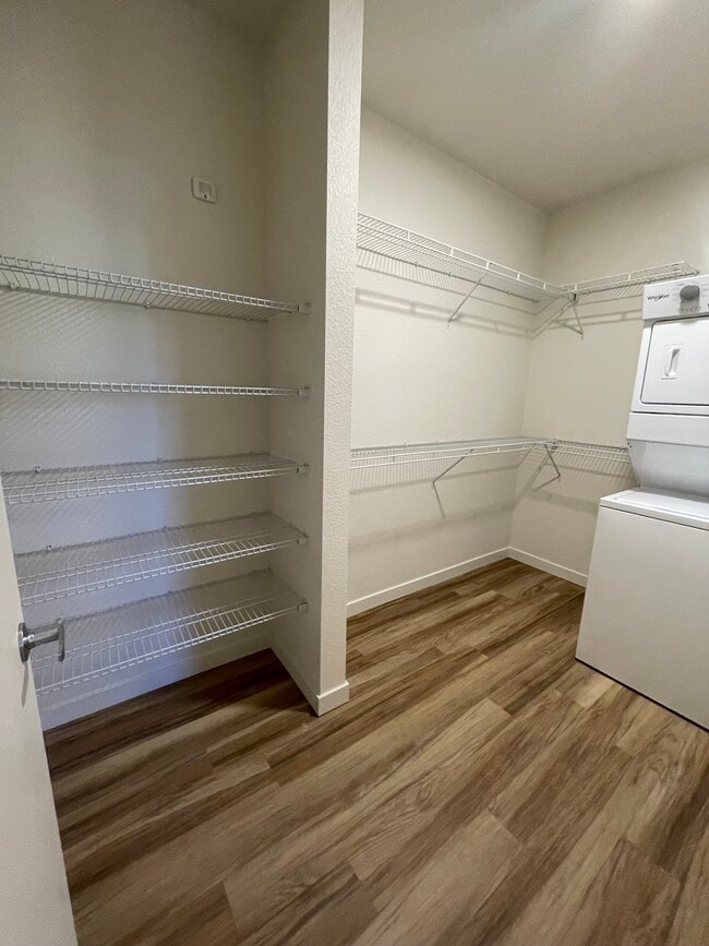 Primary closet with washer/dryer - Madera Apartments