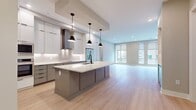 This contemporary single-level residence offers 1,560 square feet of thoughtfully designed living space. The home boasts 3 bedrooms, including a spacious 190 square foot primary suite, and 4 bathrooms for added convenience. The layout incorporates an open-concept design, seamlessly blending the kitchen and living room areas for a fluid, airy feel.

The interior is characterized by clean lines and a neutral color palette, with light gray walls and warm wood-toned flooring throughout. Built-in shelving adds both functionality and visual interest to the living areas. The rooms feature recessed lighting, contributing to the modern aesthetic while providing ample illumination.

Wide doorways and an absence of level changes suggest a focus on accessibility. The generous room proportions and multiple hallways ensure easy navigation throughout the home. With 2 closets and 4 bathrooms, the property offers abundant storage and personal space for residents and guests alike.

The combination of practical amenities and contemporary design elements creates a living environment that is both stylish and functional, suitable for a variety of lifestyle needs.
