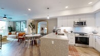 Located at 1509 Broadway in the heart of San Diego, CA, this thoughtfully designed one-bedroom, one-bathroom residence offers a well-appointed single-level layout. The open-concept kitchen is a standout feature, showcasing elegant quartz countertops with a striking veined pattern, crisp white cabinetry, a classic subway tile backsplash, and a full suite of stainless steel appliances including a gas range and French door refrigerator. A built-in entryway nook adds functional charm near the kitchen.

The living area flows seamlessly from the kitchen and dining space, featuring warm wood-look flooring throughout. A tray ceiling adds architectural dimension, while sliding glass doors open to a private balcony, bringing in natural light and outdoor views. A separate dining nook provides additional versatility.

The bedroom is a serene retreat with a soft accent wall, tray ceiling detail, ample natural light, and direct access to a spacious walk-in closet with full rod storage. The bathroom features large-format tile flooring, a walk-in shower with a teak mat, and a clean, minimalist aesthetic. Recessed lighting and a neutral palette throughout create a cohesive, modern ambiance ideal for urban living.