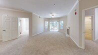 Located at 3663 Solano Ave in Napa, CA, this well-appointed 3-bedroom, 2-bathroom single-floor residence offers a thoughtfully designed layout with a warm, neutral palette throughout. The open living room is a standout space, featuring elegant crown molding, a ceiling fan, plush wall-to-wall carpeting, and a classic white-mantled fireplace that serves as a natural focal point. Large sliding glass doors invite abundant natural light and provide access to an outdoor area with greenery views.

The galley-style kitchen is equipped with stainless steel appliances, including a refrigerator, dishwasher, and range, complemented by rich dark wood cabinetry and granite-look countertops. Warm hardwood-style flooring grounds the kitchen and flows into the adjoining areas.

The primary bedroom is generously sized and includes access to a spacious walk-in closet outfitted with extensive wire shelving and hanging systems on all sides. Both bathrooms feature tiled shower-tub combinations, dark wood vanities, and light stone countertops, maintaining a consistent and clean aesthetic.

The two additional bedrooms are carpeted and well-lit, with one featuring a window overlooking lush outdoor greenery. A connecting hallway ties the layout together efficiently, making this Napa residence both functional and comfortable.