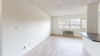Located at Morningside Ave in Toronto's east end, this well-appointed 3-bedroom, 1-bathroom unit offers a thoughtfully designed layout spread across a single floor. The open-concept kitchen and living area form the heart of the home, featuring light hardwood-style flooring, a textured ceiling, and a seamless flow between spaces. The kitchen is outfitted with crisp white cabinetry, a classic subway tile backsplash, a central island, and a full suite of stainless steel appliances including a refrigerator, stove, dishwasher, and over-the-range microwave. The living area is bright and airy, with a large window framing views of the surrounding greenery and a classic cast-iron radiator providing warmth. Each of the three bedrooms offers a clean, neutral palette with hardwood-style flooring and natural light. The primary bedroom includes a mirrored sliding door closet, maximizing both storage and the sense of space. The bathroom is finished with gleaming white subway tile surrounding a full soaker tub and shower. A private balcony extends the living space outdoors, offering open views of the treed surroundings. The unit connects via a functional hallway, keeping the layout organized and efficient throughout.