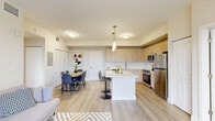 Located at 8401 NW 29th Ct in Miami, FL, this 4-bedroom, 2-bathroom single-story home offers a thoughtfully designed layout with modern finishes throughout. The open-concept kitchen and living area serves as the heart of the home, featuring light wood cabinetry, white quartz countertops, a large center island with bar seating, and a full suite of stainless steel appliances including a range, microwave, and refrigerator. Pendant lighting adds a stylish touch above the island, while light-toned vinyl plank flooring flows seamlessly throughout the space. The living area is bathed in natural light thanks to a large sliding glass door that opens to a private balcony, offering serene outdoor views of greenery. The primary bedroom is a comfortable retreat with bright windows, recessed lighting, and generous closet space. The bathrooms are finished with marble-look tile flooring, light wood vanities, white quartz countertops, and clean, neutral tones that contribute to a calm, spa-like atmosphere. A dedicated hallway connects the four bedrooms, providing a functional and efficient floor plan. The overall ambiance is modern, bright, and airy — ideal for comfortable living in the heart of Miami.