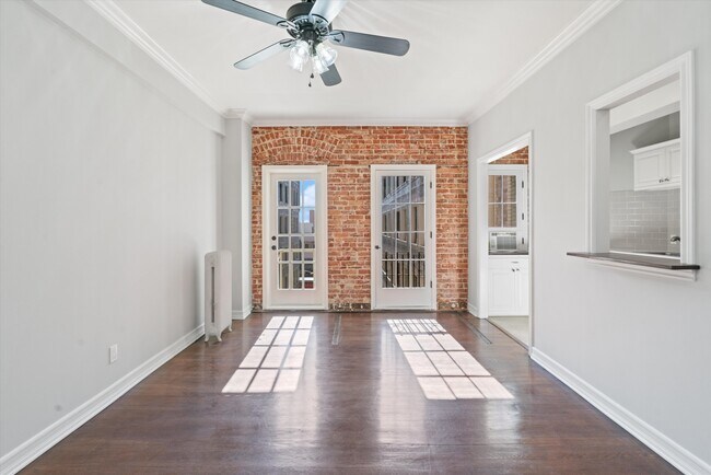 Exposed brick wall with lovely French doors leading to fire escape and Juliet balcony - 2121 James M Wood Blvd