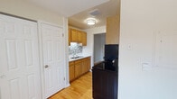 Located at 4655 Kirchoff Rd in Rolling Meadows, Illinois, this single-floor unit offers a well-organized layout with a clean, functional design throughout. Warm-toned hardwood flooring runs continuously across the main living and bedroom areas, lending a sense of cohesion and brightness to the space.

The kitchen is efficiently arranged and features warm oak cabinetry — both upper and lower — paired with a mosaic tile backsplash that adds a touch of texture and visual interest. A stainless steel sink, ample counter space, and a black refrigerator and range complete the cooking area. The kitchen connects openly to the main living area through an arched passageway, promoting an easy flow between spaces.

The living area is generously sized, bathed in natural light from a large window fitted with vertical blinds. A baseboard heating system runs along the perimeter, ensuring year-round comfort. Neutral-toned walls throughout the unit provide a versatile backdrop adaptable to a variety of interior styles.

The bathroom is tastefully appointed with a marble-topped vanity, brushed nickel fixtures, a framed mirror, and a tiled shower enclosure. Clean lines and neutral tones give the bathroom a polished, updated feel. Overall, the unit presents a practical and comfortable living environment in a well-established Rolling Meadows location.