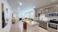 Located at 11918 Clay Road in Houston, TX 77043, this single-story, one-bedroom, one-bathroom unit offers a thoughtfully designed layout that maximizes its comfortable footprint. Light-toned wood-style flooring runs throughout, complementing the neutral color palette that creates a cohesive, modern aesthetic across all rooms.

The open-concept kitchen serves as a central hub, featuring gray shaker-style cabinetry, white subway tile backsplash, granite countertops, stainless steel appliances—including a refrigerator, range, microwave, and dishwasher—and a granite-topped island with seating. The kitchen flows directly into the living room, which benefits from multiple large, blinds-fitted windows that bring in generous natural light and is finished with a ceiling fan overhead.

The bedroom is a well-proportioned, quiet retreat with a ceiling fan, a window with blinds, and access to a spacious walk-in closet outfitted with wire shelving. The full bathroom features a subway tile tub/shower surround, a dark-cabinetry vanity with a granite countertop, and wood-style flooring. A dedicated laundry area with full-size washer and dryer connections completes the unit.