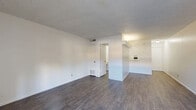 Located at 3253 Hillcrest Drive in San Antonio, TX, this single-floor unit offers a functional and efficient layout across a well-organized floor plan. The living area is a standout feature, finished with durable wood-look flooring and illuminated by natural light streaming through large sliding glass doors that open directly onto a private patio — ideal for indoor-outdoor living. The textured ceilings are consistent throughout, adding a classic residential character to the space.

The kitchen is compact yet practical, equipped with white cabinetry, a coil-burner electric range, a full-size refrigerator, and a light-toned countertop. Adjacent to the kitchen is a dedicated dining area and a pantry, providing convenient storage and meal prep flow. A utility room adds further practicality to the layout.

The generously sized primary bedroom occupies a substantial portion of the floor plan, offering ample room for furnishings. It connects to a full bathroom featuring a tiled tub-shower combination, a vanity with a speckled countertop, and tile flooring. A hallway and closet complete the interior, ensuring organized storage throughout.

Clean white walls, consistent flooring, and a straightforward layout make this space an informative, move-in-ready unit suited for those seeking practical, single-level living in San Antonio.