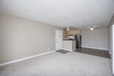 Located at 652 Moss Street in Chula Vista, CA, this two-bedroom, one-bathroom residence offers a functional and comfortable single-floor layout. The open-plan living, dining, and kitchen area serves as the heart of the home, where soft carpet and warm beige tones create an inviting atmosphere. The living room features a textured ceiling, a wall-mounted heating unit, and a sliding glass door that opens onto a private balcony with outdoor views — filling the space with natural light. The kitchen is well-appointed with light wood cabinetry, dark granite-style countertops, stainless steel appliances including a gas range and refrigerator, and durable wood-look flooring. A peninsula counter provides additional workspace and a natural divide between the kitchen and living areas, complemented by a ceiling fan overhead. Both bedrooms are carpeted and finished in neutral tones, each with windows that bring in natural light. The primary bedroom offers generous proportions and ample room for furnishings. The bathroom features a full tub-shower combo, wood-look flooring, and a vanity with matching granite-style countertops. With five closets throughout, storage is plentiful. This residence provides a well-rounded, practical living environment in the heart of Chula Vista.