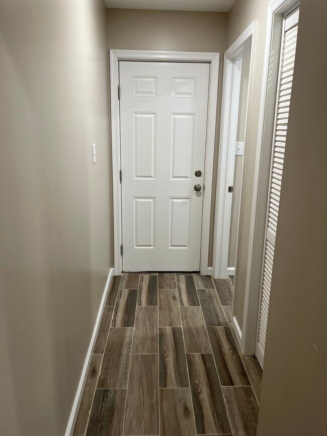Main floor hallway to half bathroom and washer/dryer setup - 5311 Ogden St