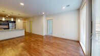 Located at 704 Williamson St in Madison, WI, this two-bedroom, two-bathroom unit offers a well-designed single-floor layout with a clean, modern aesthetic. The open-concept kitchen and living area serve as the heart of the space, featuring rich dark cabinetry, granite countertops, stainless steel appliances including a range, microwave, dishwasher, and refrigerator, and a peninsula with pendant lighting overhead. Warm hardwood flooring runs throughout the main living areas, adding a welcoming feel. A dedicated entryway provides built-in closet storage upon entry. Conveniently tucked nearby is an in-unit stacked washer and dryer. The spacious living room features recessed lighting and opens to the rest of the unit with ease. Both bedrooms are carpeted and well-proportioned, with the primary bedroom offering a walk-in closet with full wire shelving and ample natural light from a large window. The second bedroom includes a built-in bi-fold closet. The bathrooms feature clean, neutral finishes, with one including a full soaking tub and shower combo with tiled flooring. The overall ambiance is bright, functional, and move-in ready, ideal for those seeking contemporary urban living in Madison's vibrant Williamson Street corridor.