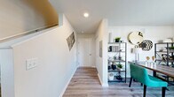 Located at 16966 Pond Willow Dr in Orland Park, Illinois, this three-story townhome offers three bedrooms and three full bathrooms across a well-organized layout. The entry level provides a welcoming introduction to the home, while the main living floor above features a bright, open living room with wood-look flooring, large sliding glass doors, and direct access to a private balcony overlooking the neighborhood streetscape. The kitchen is thoughtfully designed with light cabinetry, granite countertops, stainless steel appliances, a central island with bar seating, and pendant lighting that adds a modern touch. Natural light flows freely throughout this level. The upper floor hosts the bedrooms, each fitted with plush carpeting and windows that bring in ample daylight. The primary bedroom is generously sized with multiple windows. The additional bedrooms are well-proportioned, with one offering flexibility as a home office. All three bathrooms feature granite vanities, light wood-tone cabinetry, and wood-look tile flooring, with options for both walk-in showers and shower-tub combinations. A staircase connects all three levels seamlessly. The balcony provides pleasant outdoor views of the surrounding community, completing this functional and stylish multi-level home.