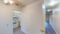 This two-floor residence offers a practical and straightforward layout across its levels. The living areas are finished with light-toned laminate flooring, lending a clean and cohesive look, while sliding glass doors invite natural light and provide outdoor access. The kitchen is equipped with a coil-burner electric range, oven, refrigerator, and dishwasher, all in white. Cream-toned cabinetry with a tile backsplash lines the walls, offering generous storage and counter space in a compact, efficient arrangement. The bathroom features full white tile surround enclosing a bathtub and shower combination, with a window providing natural ventilation. The upper floor showcases warm, natural hardwood flooring across the bedrooms, each offering a bright and open feel. Windows overlooking the surrounding greenery bring in natural light, enhancing the airy atmosphere of these rooms. Closet space is provided within the bedrooms, adding to the overall functionality. With neutral wall tones throughout and a consistent, understated aesthetic, this residence presents a versatile canvas well-suited for personalization.