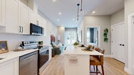Located at 162 McCarthy Road West in Stratford, Ontario, this well-appointed one-bedroom, one-bathroom unit offers a smart and efficient single-floor layout with contemporary finishes throughout. The entrance opens directly into the heart of the home, where light hardwood flooring flows seamlessly through the kitchen and main living areas. The modern kitchen is a standout feature, boasting crisp white shaker cabinetry with matte black hardware, a white quartz waterfall island with seating for two, stainless steel appliances including a French door refrigerator and range, and a classic subway tile backsplash — all illuminated by a stylish pendant light. The living room is bright and inviting, with large windows that frame outdoor views and fill the space with natural light, creating a relaxed and airy ambiance. The bedroom offers a comfortable retreat with a large window, a double sliding-door closet, and neutral tones that contribute to a calm atmosphere. The bathroom is finished to a high standard, featuring a white shaker vanity with quartz countertop, matte black fixtures, a large framed mirror, and elegant marble-look tile flooring. This unit combines practical design with modern aesthetics, making it a polished and functional home in Stratford.