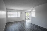 Located at 20455 Anza Ave in Torrance, CA, this well-appointed 2-bedroom, 2-bathroom residence offers a thoughtfully designed single-level layout. The open-concept living and dining area is bright and airy, featuring contemporary wood-style laminate flooring, a textured ceiling, and large windows with vertical blinds that invite abundant natural light. A ceiling fan adds comfort, while a distinctive arched architectural detail adds character to the space. Sliding glass doors lead to a private balcony with outdoor views, seamlessly connecting indoor and outdoor living.

The kitchen is efficiently designed with white shaker cabinetry, granite countertops, a marble-style tile backsplash, a double stainless steel sink, and stainless steel appliances, all set atop light ceramic tile flooring. Both bedrooms are generously proportioned, with the primary bedroom offering a comfortable footprint, wood-style flooring, and a sliding door to the outdoors. The second bedroom also features wood-style flooring and ample closet space. Three closets throughout the unit provide excellent storage. The two bathrooms are clean and functional, one featuring a glass-enclosed shower. The hallway connects all rooms in a practical and efficient flow.