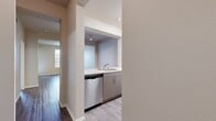 This contemporary 1-bedroom, 1-bathroom apartment in Rancho Cucamonga offers 640 square feet of efficiently designed living space. The open-concept layout maximizes functionality, with a spacious living room that seamlessly connects to the dining area and kitchen. Large windows flood the space with natural light, creating a bright and airy atmosphere.

The kitchen is equipped with modern stainless steel appliances, including a gas range and over-the-range microwave. Sleek light-toned cabinetry and white countertops contribute to the clean, minimalist aesthetic. The bedroom, measuring 130 square feet, features a walk-in closet with built-in organizers for ample storage.

Throughout the apartment, durable wood-look flooring adds warmth and easy maintenance. The bathroom showcases contemporary fixtures and a combination bathtub-shower. A standout feature is the in-unit laundry room with full-sized washer and dryer, offering unparalleled convenience.

The apartment includes a private balcony, perfect for outdoor relaxation or dining. With its thoughtful design and modern amenities, this apartment provides a comfortable and stylish living space in a desirable Rancho Cucamonga location.