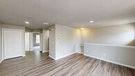Located at 80 River Chase Dr in Dover, Delaware, this one-bedroom, one-bathroom residence offers a well-designed single-floor layout with a practical and cohesive interior. The combined kitchen and living area forms the heart of the home, featuring wood-look luxury vinyl plank flooring, neutral-toned walls, and recessed lighting. The kitchen is outfitted with crisp white cabinetry, a suite of black appliances including a refrigerator, dishwasher, and range, along with a single-basin sink and a louvered-door closet for additional storage. The open living area benefits from large windows dressed with horizontal blinds, allowing natural light to fill the space, and includes a half-wall partition that adds architectural definition. The bedroom is a comfortable, well-proportioned retreat featuring plush wall-to-wall carpeting, vaulted ceilings that lend a sense of openness, and a large window providing natural light. A dedicated closet adds convenient storage directly off the bedroom. The bathroom is cleanly finished with a white vanity, a mirrored medicine cabinet with overhead lighting, a toilet, and a full bathtub with shower, all set on wood-look flooring that ties in with the rest of the home. The overall aesthetic is clean, modern, and move-in ready.