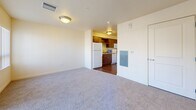 Located at 3500 S Sherman St in Englewood, Colorado, this efficiently designed single-floor unit offers a thoughtfully organized layout across its cozy footprint. The kitchen is equipped with warm wood-toned cabinetry, a double-basin sink, white appliances including a refrigerator and dishwasher, and hardwood-style flooring that adds a polished contrast to the cabinetry. It opens directly into the living room, creating a connected and functional flow throughout the main living area. The living room features neutral wall-to-wall carpeting and receives natural light through a large sliding glass door fitted with vertical blinds, which provides access to a private balcony with outdoor views. An additional window further brightens the space. The bathroom is finished with wood-look vinyl flooring, a vanity with a single sink and wood cabinetry, and a shower with a curved curtain rod. Two closets provide practical storage solutions throughout the unit. A dedicated laundry area adds everyday convenience. The overall aesthetic is clean and neutral, with light-toned walls, flush-mount ceiling fixtures, and consistent finishes throughout, making the space feel cohesive and move-in ready.
