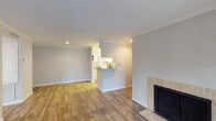 Located at 10027 Spice Ln in Houston, TX, this single-floor residence offers a thoughtfully designed layout with a welcoming open-concept living and dining area. The living room is a standout space, featuring rich wood-style flooring, elegant crown molding, and a tile-surround fireplace that serves as a natural focal point. French doors open to the outdoors, flooding the room with natural light and providing a seamless connection to the exterior. The galley-style kitchen is efficiently arranged with white cabinetry, granite-style countertops, white appliances, and a pass-through breakfast bar that connects to the living area. Wood-style flooring continues through the kitchen, which also includes a dedicated laundry area. The bedrooms are carpeted for comfort, with one room featuring dual windows and a ceiling light fixture, and another offering a large wall and natural light through window blinds. The bathrooms are clean and functional — one includes a spacious vanity with a granite-style countertop and a large mirror, while the other features a tub-shower combination. The home's neutral color palette and consistent finishes create a cohesive, move-in-ready atmosphere throughout.