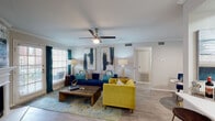 Located at 9605 E Valley Ranch Pkwy in Irving, TX, this single-story residence offers a thoughtfully designed layout that balances functionality and style. The living area serves as the heart of the space, featuring wood-style flooring, crown molding, and a ceiling fan overhead. Large windows and a glass patio door allow generous natural light to fill the room while providing outdoor views, creating a bright and welcoming atmosphere. A dedicated dining nook sits adjacent to the living area, offering a defined space for meals without disrupting the open flow.

The galley-style kitchen is efficiently organized with white cabinetry, light quartz-style countertops, a tile backsplash, and stainless steel appliances including a refrigerator and dishwasher. A window at the end of the kitchen brings in additional natural light.

The bedroom is carpeted and comfortably scaled, featuring a ceiling fan, a window with outdoor views, and ample room for a seating area alongside standard furniture. The full bathroom includes a tub-shower combination with tile surround, wood-style flooring, and a white vanity with storage. Overall, the unit presents a clean, contemporary aesthetic throughout.