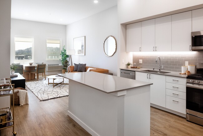 Kitchen and living room with hard surface flooring - Avalon Bothell Commons