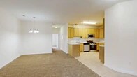 Located at 1200 Regency Ct in Middletown, NY, this single-floor, 2-bedroom, 2-bathroom residence offers a thoughtfully designed layout with a comfortable and functional living environment. The open-concept living and dining area is anchored by warm carpeting and a elegant chandelier, creating a welcoming atmosphere. The space flows seamlessly into the kitchen, which features light wood cabinetry, stainless steel appliances including a gas range, microwave, and dishwasher, complemented by tile flooring and a peninsula that connects the cooking and living areas. A pantry provides additional storage convenience.

The primary bedroom is generously sized, boasting a striking bay window arrangement that fills the room with natural light and offers exterior views. The second bedroom also benefits from natural light through its large window and offers comfortable carpeted flooring. Both bathrooms are finished with neutral tile floors, wood-toned vanities, and clean, bright fixtures. The residence also includes a dedicated laundry area, utility room, and four closets distributed throughout, ensuring ample storage. The neutral color palette and consistent finishes throughout create a cohesive and move-in-ready living space.