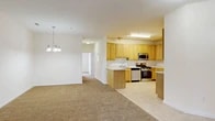 Located at 1200 Regency Ct in Middletown, NY, this single-floor, 2-bedroom, 2-bathroom residence offers a thoughtfully designed layout with a comfortable and functional living environment. The open-concept living and dining area is anchored by warm carpeting and a elegant chandelier, creating a welcoming atmosphere. The space flows seamlessly into the kitchen, which features light wood cabinetry, stainless steel appliances including a gas range, microwave, and dishwasher, complemented by tile flooring and a peninsula that connects the cooking and living areas. A pantry provides additional storage convenience.

The primary bedroom is generously sized, boasting a striking bay window arrangement that fills the room with natural light and offers exterior views. The second bedroom also benefits from natural light through its large window and offers comfortable carpeted flooring. Both bathrooms are finished with neutral tile floors, wood-toned vanities, and clean, bright fixtures. The residence also includes a dedicated laundry area, utility room, and four closets distributed throughout, ensuring ample storage. The neutral color palette and consistent finishes throughout create a cohesive and move-in-ready living space.