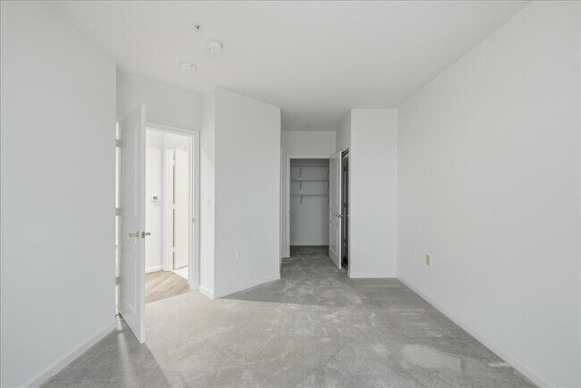 Building Photo - Commuter’s Paradise! Ground-Level 2BR Condo  Welcome home to this stunning, sun-filled 2-bedroom ...
