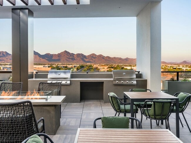 Grill, gather, and unwind with sweeping mountain views as your backdrop—this rooftop oasis is perfect for golden hour cookouts and cozy firepit conversations. - Modera Scottsdale