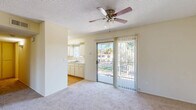 Located at 4515 3rd Street in La Mesa, California, this one-bedroom, one-bathroom unit offers a practical and comfortable single-floor layout. The living and dining area forms the heart of the space, featuring neutral carpet flooring, soft cream-toned walls, a textured ceiling, and a ceiling fan with light fixture. A sliding glass door opens to a private balcony, allowing natural light to pour in and providing pleasant outdoor views of the surrounding greenery. The rich, dark-stained six-panel front door adds a warm, classic accent to the entryway.

The kitchen is efficiently designed with ample cabinetry, a sink, and a window that brings in additional natural light. It connects seamlessly to the dining area via hardwood-style flooring, creating a distinct transition between spaces.

The bedroom is a well-proportioned retreat featuring carpeting, a window with natural light, and a wide sliding-door closet that offers generous storage. A hallway connects the bedroom to the rest of the unit, maintaining a logical and functional flow throughout.

The bathroom is clean and straightforward, featuring a full soaking tub with a tiled shower surround and chrome fixtures. The overall ambiance of this unit is bright, neutral, and move-in ready, suited for comfortable everyday living in the heart of La Mesa.