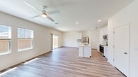 Located at 2601 Crystal Bend Drive in Pflugerville, TX, this two-story home offers four bedrooms, three bathrooms, and a well-designed layout spread across two floors. The main level features an open-concept kitchen and living area filled with natural light from large windows and a sliding glass door that opens to a fenced backyard. The kitchen is appointed with crisp white cabinetry, a subway tile backsplash, stainless steel appliances, and a central island with a built-in sink — ideal for both cooking and casual dining. Wood-look plank flooring runs throughout the main living areas, complemented by recessed lighting and a ceiling fan that enhance the bright, airy atmosphere. The upper floor houses the majority of the bedrooms, including a generously sized primary suite with a walk-in closet outfitted with built-in shelving. Bedrooms feature plush carpet flooring and ceiling fans, with several offering views of the neighborhood. A dedicated laundry area with a full-size washer and dryer is also included. The attached garage provides ample storage and parking space. Clean, neutral finishes throughout create a move-in ready home with a modern, functional aesthetic.