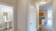 Located at 2014 Avalon Pkwy in McDonough, GA, this well-appointed 2-bedroom, 2-bathroom residence offers a thoughtfully designed single-floor layout. The open living area features warm wood-look flooring, neutral-toned walls, and crown molding that adds a refined touch. A standout architectural detail is the arched built-in niche with granite-topped cabinetry, creating a charming focal point between the living and dining areas. Natural light flows generously through multiple large windows fitted with blinds, offering pleasant views of the surrounding greenery.

The kitchen is equipped with warm wood cabinetry, granite countertops, and stainless steel appliances, with convenient access to additional storage closets nearby. Both bedrooms are carpeted for comfort and include dedicated walk-in closets outfitted with wire shelving systems for ample organization. The primary bedroom is generously sized, featuring its own walk-in closet with built-in shelving and a window for natural light. The bathrooms include a tub-shower combination with tile surround and wood-look flooring.

A private balcony extends the living space outdoors, overlooking a well-maintained landscape of mature trees — ideal for relaxing or enjoying the Georgia weather. Three closets throughout the home ensure excellent storage capacity.