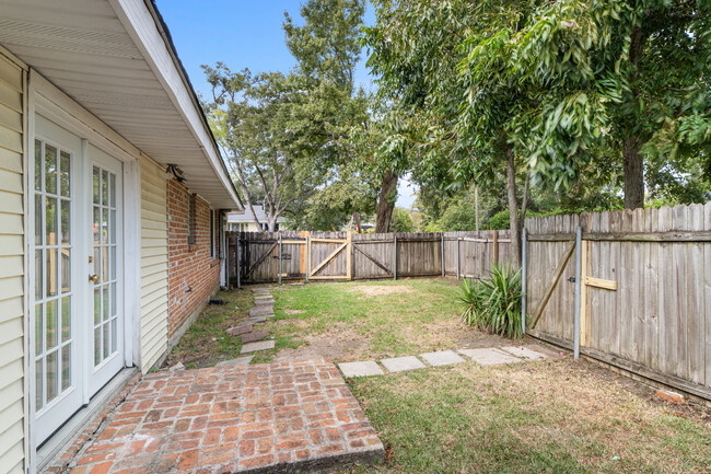 Side yard with gated entrance to parking - 9441 Sharla Dr