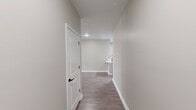 This contemporary 990 square foot apartment offers a well-designed living space with two bedrooms and two bathrooms. The open-concept layout creates a seamless flow between the living areas, enhancing the sense of space. The kitchen is a standout feature, boasting modern white cabinetry, sleek stainless steel appliances, and elegant marble-look countertops with a convenient breakfast bar.

Large windows in the living area and bedrooms flood the space with natural light, while white plantation shutters provide privacy and light control. The neutral color palette, featuring light gray walls and warm wood-tone vinyl flooring throughout, creates a cohesive and inviting atmosphere.

The bathrooms are tastefully appointed with granite countertops and glass-enclosed showers. The in-unit laundry room adds convenience, while the walk-in closet offers ample storage space. The primary bedroom, measuring 140 square feet, provides a comfortable retreat.

Located in Plainfield, IN, this single-story apartment combines modern amenities with a practical layout, making it an ideal home for those seeking a contemporary living space with attention to detail and functionality.
