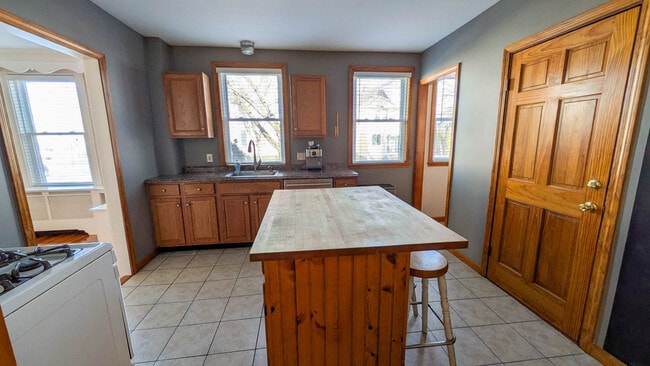 Kitchen with butcher block island, gas cooking and rare walk-in pantry offering excellent storage - 37 Glover Ave