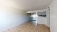 Located at 2540 W Maryland Ave in Phoenix, AZ, this single-story, one-bedroom, one-bathroom unit offers a functional and straightforward layout across a compact but well-utilized floor plan. Light-toned ceramic tile flooring runs consistently throughout every room, giving the space a cohesive and easy-to-maintain feel.

The open living area is bright and airy, featuring a textured ceiling, a ceiling fan, and sliding glass doors that allow natural light to flow in. It connects seamlessly to the kitchen via a half-wall breakfast bar. The galley-style kitchen is efficiently designed with gray upper and lower cabinetry, light countertops, a single-basin sink, a coil-burner electric range, and a full-size refrigerator — providing ample storage and workspace.

The bedroom is generously sized, offering a windowed wall fitted with vertical blinds, a built-in closet, and a textured ceiling with a ceiling vent for climate control. The full bathroom includes a combined tub and shower with a curtain rod, a vanity with storage, and tile flooring.

A dedicated laundry and utility area houses the water heater and includes shelving, rounding out the practical amenities of this well-organized Phoenix residence.