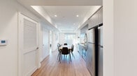 Located on Fountain Avenue in the heart of Los Angeles, this thoughtfully designed single-level residence offers four bedrooms and three bathrooms within a compact, efficiently arranged floor plan. Light wood flooring flows continuously throughout, lending warmth and visual continuity across every room.

The open-plan kitchen and dining area serves as the social hub of the home. The kitchen is outfitted with stainless steel appliances — including a full-size refrigerator, gas range, and built-in microwave — complemented by gray cabinetry with ample storage and a white tile backsplash. A dining table with seating for six sits adjacent, illuminated by recessed lighting and a tray ceiling detail.

A central hallway connects the living spaces to the four bedrooms, each featuring gray built-in closets and clean white walls. The primary bedroom is a well-proportioned private retreat. The living room opens to an outdoor area through sliding glass doors, bringing in natural light and views of the surrounding neighborhood.

All three bathrooms maintain the home's clean, modern aesthetic, featuring white tile flooring, glass-enclosed showers, and gray vanity cabinetry with mirrored medicine cabinets. In-unit laundry is also accessible. The overall design is minimal, bright, and functional — well-suited to the dynamic Los Angeles lifestyle.