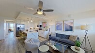 This well-appointed single-floor residence showcases a clean, modern design with an open-concept layout that seamlessly connects the kitchen, dining, and living areas. The kitchen is a standout feature, outfitted with crisp white cabinetry extending to the ceiling, striking marble-look quartz countertops, stainless steel appliances including a French door refrigerator and electric range with over-the-range microwave, a deep undermount sink, and a central island with pendant lighting overhead. Light wood-look flooring flows throughout, enhancing the bright and airy atmosphere. The spacious living area benefits from large windows that invite abundant natural light and is finished with a ceiling fan for added comfort. The bedroom is generously sized, offering a ceiling fan, recessed lighting, and floor-to-ceiling sliding glass doors that open to a private balcony with open city views. The bathroom features a clean, minimalist design with a frameless glass walk-in shower, white cabinetry, and distinctive dark hexagonal tile flooring that adds a bold contrast. Overall, the residence presents a cohesive, contemporary aesthetic with thoughtful finishes and a functional, open floor plan suited for modern living.