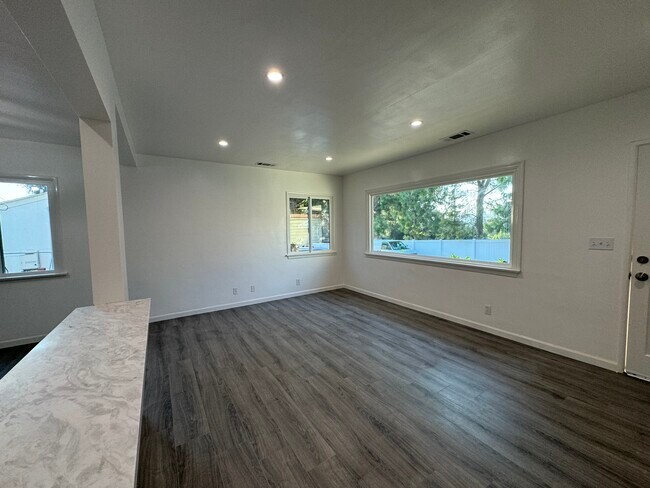 Living room with large picture window - 11052 Plainview Ave