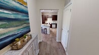 Located at 1211 Gray Birch Way in Knoxville, TN, this well-appointed single-story, three-bedroom, two-bathroom home offers a thoughtfully designed layout with a welcoming flow throughout. Wide hallways with wood-look flooring connect the main living areas, creating a cohesive and open feel from the moment you enter.

The kitchen serves as a central highlight, featuring rich dark wood cabinetry, granite countertops, stainless steel appliances, and a curved island with bar seating — ideal for casual dining or entertaining. Track lighting overhead adds a modern touch. The adjoining living room is bright and comfortable, complete with a ceiling fan and warm neutral tones.

The primary bedroom is generously sized with plush carpeting, a ceiling fan, natural light from large windows, and direct access to a private en-suite bathroom. The additional bedrooms are well-proportioned, each with carpeted floors, closets, and natural light. Both bathrooms feature dark wood vanities with granite countertops and tub-shower combinations with tiled surrounds.

A dedicated laundry room with washer/dryer hookups and wire shelving adds everyday convenience. Three closets throughout the home provide ample storage. The space combines practical functionality with a clean, contemporary aesthetic suited for comfortable living.