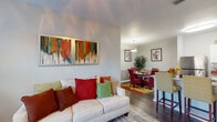 Located at 7101 Wilson Blvd in Jacksonville, Florida, this single-floor residence offers a thoughtfully designed open layout that seamlessly connects the living, dining, and kitchen areas. A welcoming entryway with crisp white paneled doors and warm wood-style flooring sets the tone throughout the common spaces.

The living room is bright and inviting, featuring a ceiling fan, large windows that invite natural light and outdoor views, and ample space for comfortable seating. It flows effortlessly into the dining area, which is anchored by a pendant light fixture and room for a full dining set.

The galley-style kitchen is well-appointed with white shaker cabinetry, granite-look countertops, stainless steel appliances, and a generous walk-in pantry for added storage. Wood-style flooring continues through this functional and stylish space.

Two bedrooms provide comfortable retreats, each featuring ceiling fans, plush carpeting, and windows with outdoor views. The primary bedroom includes direct access to a private bathroom. Both bathrooms are finished with white cabinetry, granite-topped vanities, wood-style flooring, and tub-shower combinations, offering a clean and polished aesthetic throughout.