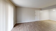 This 610 square foot, one-bedroom apartment in Raleigh, NC, showcases a thoughtful design that maximizes space and functionality. The unit features a cohesive aesthetic with neutral-toned walls and warm wood-look flooring throughout, creating a seamless flow between rooms. The living area is bright and airy, benefiting from large windows and a sliding glass door that leads to an outdoor space, enhancing the sense of openness. The bedroom, measuring 180 square feet, is equipped with a modern ceiling fan and ample closet space. The updated kitchen boasts sleek gray cabinetry, contrasting black appliances, and a light-colored countertop, offering a contemporary feel in a galley-style layout. The bathroom features a practical combination of white fixtures and neutral tones, with a shower-tub combo for versatility. Additional amenities include in-unit laundry facilities and a dedicated storage area with built-in shelving, adding to the apartment's overall efficiency and livability.