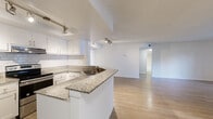 Located at 10645 Hammocks Blvd in Miami, FL, this well-appointed three-bedroom, one-bathroom residence offers a thoughtfully designed single-floor layout with a generous overall footprint. Light wood-style flooring runs throughout, creating a cohesive and clean aesthetic across all rooms.

The open-concept living area is bright and airy, featuring vaulted ceiling lines that lend a sense of height and volume. It flows seamlessly into the kitchen, which is equipped with white cabinetry, granite countertops, a subway tile backsplash, a stainless steel sink, and a peninsula that defines the space without sacrificing openness.

The spacious primary bedroom offers ample room for furnishings and includes dedicated closet space. Two additional bedrooms provide versatility for various living arrangements, with one room featuring a window that brings in natural light and outdoor views. Two closets serve the unit, including a walk-in style closet with wire shelving for organized storage.

The bathroom is clean and functional, featuring a tiled walk-in shower, a granite-topped vanity with an undermount sink, and a large mirror. A dedicated laundry room houses full-size washer and dryer units alongside the water heater and HVAC system. The unit also includes a balcony, adding a welcome outdoor extension to the living space.