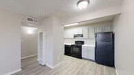 Located at 330 Waymore Dr in El Paso, TX, this single-floor, one-bedroom, one-bathroom unit offers a well-organized layout across a compact but functional footprint. Light wood-look flooring runs throughout the space, lending a clean, cohesive aesthetic to every room. The open kitchen is a standout feature, showcasing gray shaker-style cabinetry, a classic white subway tile backsplash, white countertops, and black appliances including a range, built-in microwave, and refrigerator. A vertical HVAC unit is conveniently positioned near the kitchen entry. The living area is bright and open, benefiting from a large window that invites natural light and a ceiling fan with integrated lighting for added comfort. The bedroom offers a similarly airy feel, with a ceiling fan, a window with blinds, and two closets providing ample storage. One wall in the bedroom features painted concrete block construction, adding an element of character and solidity. Textured ceilings are present throughout the unit. The overall design is clean and neutral, making the space easy to personalize. With two closets and a practical floor plan, this unit is a smart and comfortable option in the El Paso area.