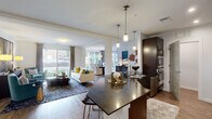 Located at 214 Bellemeade St in Greensboro, NC, this well-appointed 2-bedroom, 3-bathroom single-floor residence offers a thoughtfully designed open-concept layout. The kitchen is a standout, featuring dark granite countertops, rich espresso cabinetry, a subway tile backsplash, stainless steel appliances, and a peninsula with bar seating illuminated by sleek pendant lighting. The kitchen flows seamlessly into the living and dining areas, which are bathed in natural light from large windows and sliding glass doors leading to an outdoor patio. The living room offers generous proportions, while the dining area showcases floor-to-ceiling windows framing outdoor views. The spacious primary bedroom features plush carpeting, a ceiling fan, and a large window overlooking greenery, complemented by a well-appointed en-suite bathroom with a dual-sink vanity, dark wood cabinetry, and a walk-in shower. Two dedicated closets provide ample storage. A in-unit laundry space with a stacked washer and dryer adds everyday convenience. Throughout the residence, hardwood-style flooring, neutral tones, and modern finishes create a cohesive, contemporary aesthetic suited for comfortable urban living.
