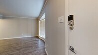 This thoughtfully designed single-floor residence offers 1 bedroom and 2 bathrooms across a compact yet functional layout. The living room is an immediate highlight, anchored by a graceful curved bay window that floods the space with natural light and is complemented by elegant crown molding and rich, dark hardwood-style flooring that extends throughout the home.

The kitchen is a standout feature, showcasing white cabinetry, a classic subway tile backsplash, stone-topped counters, and a peninsula breakfast bar with stylish pendant lighting overhead. A ceiling fan adds comfort to the adjacent dining area, which flows seamlessly from the kitchen.

The spacious bedroom includes two closets and its own ceiling fan, providing ample storage and comfort. A charming built-in bookcase with multiple shelves, also adorned with crown molding, adds character and practicality to the space.

The bathrooms are clean and modern, with one featuring a white vanity, stone countertop, framed mirror, and wood-look tile flooring. Neutral warm-gray walls throughout the home create a cohesive, calming palette. A smart lock on the front entry adds a contemporary, convenient touch. Overall, the space combines practical functionality with thoughtful design details.