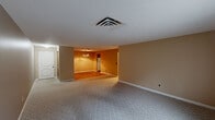 Located at 1616 S Main St in North Canton, Ohio, this 2-bedroom, 1-bathroom residence offers a practical and comfortable single-floor layout with a thoughtfully arranged floor plan. The living area is generously proportioned, featuring neutral-toned carpet, textured ceilings, and warm beige walls that create a welcoming atmosphere throughout. Sliding glass doors lead to a private balcony, allowing natural light to fill the space while providing a pleasant outdoor view.

The galley-style kitchen is outfitted with rich wood cabinetry, white tile backsplash, white countertops, and hardwood flooring, opening conveniently to a dedicated dining room accented by a classic chandelier. The primary bedroom is notably spacious, offering ample room and direct access to the hallway. The second bedroom also features carpeted flooring, a window for natural light, and a warm wood-toned closet door. Five closets throughout the unit provide exceptional storage.

The bathroom includes a wide vanity with a large mirror, white cabinetry, and louvered closet doors nearby. A welcoming entrance and hallway connect all areas seamlessly. The overall ambiance is clean, neutral, and move-in ready, suited for comfortable everyday living.
