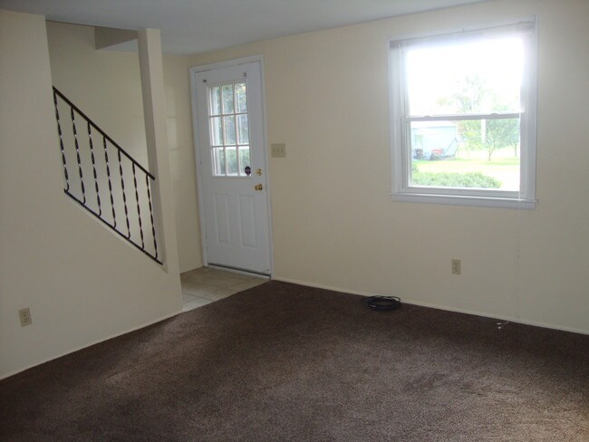Living room and stairwell to second floor. - 708 Charlotte Ave