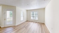 Located in Raleigh, NC, this single-floor residence offers a practical and comfortable layout with two bedrooms, two full bathrooms, a combined kitchen and living area, a hallway, and a dedicated laundry room. The space features light wood-style vinyl flooring throughout the main living and wet areas, lending a clean, cohesive look.

The galley-style kitchen is equipped with light wood cabinetry, light-toned countertops, white appliances including an electric range, dishwasher, and refrigerator, and provides a pass-through view into the adjacent living area. The living room receives natural light through multiple windows with blinds, creating a bright and open atmosphere.

Both bedrooms are finished with plush wall-to-wall carpeting and feature windows that allow natural light in. The primary bedroom is generously sized, offering ample space, while the second bedroom also includes a closet and window. Each bathroom features a vanity with light wood cabinetry, a tub-shower combination with chrome fixtures, and matching wood-style flooring. The dedicated laundry room includes built-in shelving, appliance hookups, and dryer venting, offering added convenience. Neutral wall tones and textured ceilings are consistent throughout the residence.