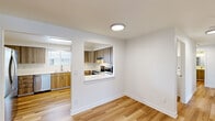 Located at 2909 NE 57th Ave in Vancouver, WA, this single-floor, 4-bedroom, 2-bathroom home offers a well-designed layout with modern updates throughout. The open living room features light hardwood-style flooring and a pass-through window that connects seamlessly to the kitchen, creating a bright and cohesive common area. The kitchen is outfitted with warm wood-toned cabinetry, white quartz countertops, stainless steel appliances including a range and microwave, and ample cabinet storage, making it both functional and visually appealing. The four bedrooms are carpeted for comfort, with windows providing natural light and views of surrounding greenery. The primary bedroom stands out with dual sliding-door closets, offering generous storage. The two bathrooms are finished with wood-grain vanities, white quartz countertops, and a tub-shower combination. A dedicated laundry room houses a full-size washer and dryer, adding everyday convenience. Throughout the home, a clean, neutral color palette and consistent modern finishes create a cohesive and inviting atmosphere, making this property a well-appointed option in the Vancouver, WA area.