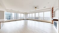 Located in the heart of Dallas, this generously sized four-bedroom, five-bathroom residence offers an exceptional blend of modern design and urban luxury. The open-concept living room is a showstopper, featuring a dramatic wall of floor-to-ceiling windows that flood the space with natural light and frame sweeping panoramic views of the Dallas skyline and surrounding cityscape. Light hardwood flooring flows throughout, complemented by clean-lined dark baseboards that add a refined contrast.

The gourmet kitchen is outfitted with custom warm-toned wood cabinetry, a full suite of stainless steel appliances, and an eye-catching marble-inspired backsplash, all anchored by a spacious island ideal for both cooking and entertaining.

The generously proportioned primary bedroom suite includes a large walk-in closet and a spa-caliber en-suite bathroom featuring a freestanding soaking tub, a glass-enclosed tile shower, and a dual-sink vanity with dark granite countertops. Additional bathrooms echo this refined aesthetic, with large-format stone tile and sleek chrome fixtures. Bedrooms are bright and well-sized, each with access to walk-in closets. The dedicated laundry room provides added convenience with built-in cabinetry and a utility sink.
